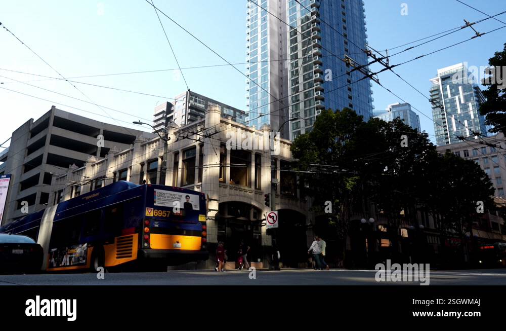 Low angle of seattle public transportation bus driving next to a car on