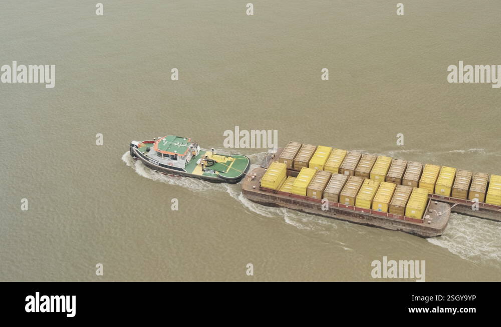 Aerial View of Tug Boat towing Cargo of Shipping Containers on River ...