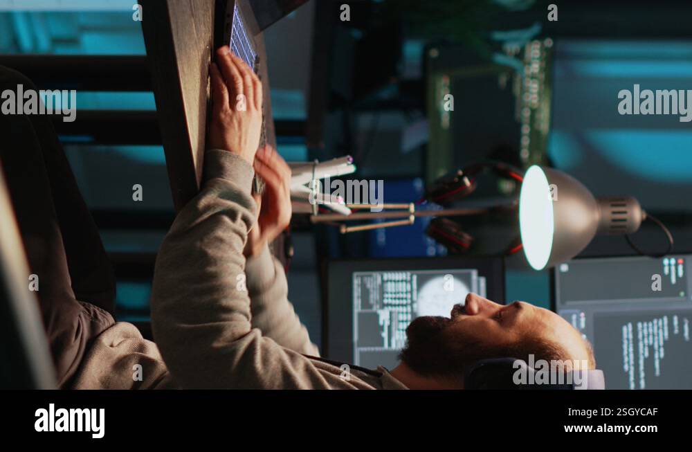 Vertical video: Software engineer typing programming code on laptop ...