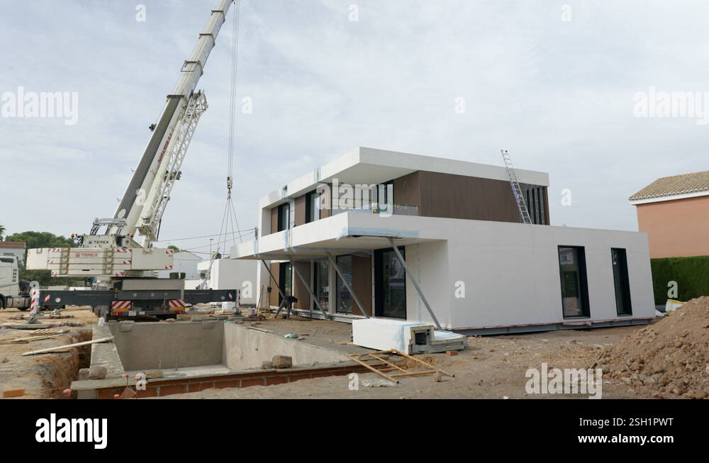 Incomplete modular housing construction site structure suspended by ...