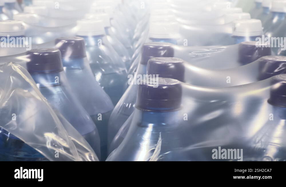 Two-liter bottles of mineral water packed in 6 bottles stand in ...