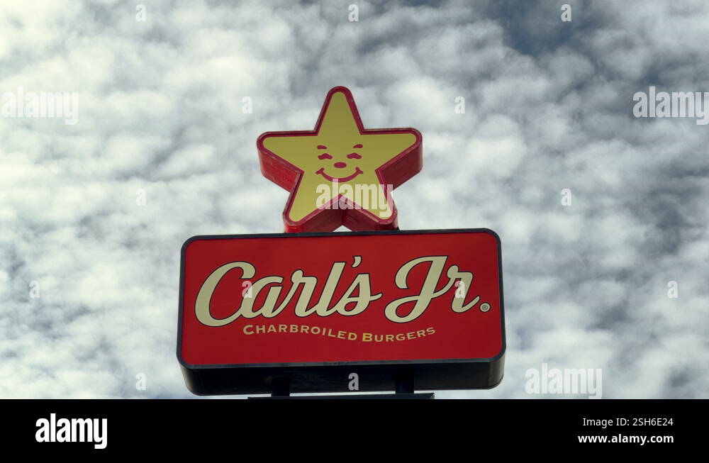 4K HD video Zooming in on Carl's Jr sign with cloudy sky behind Stock ...