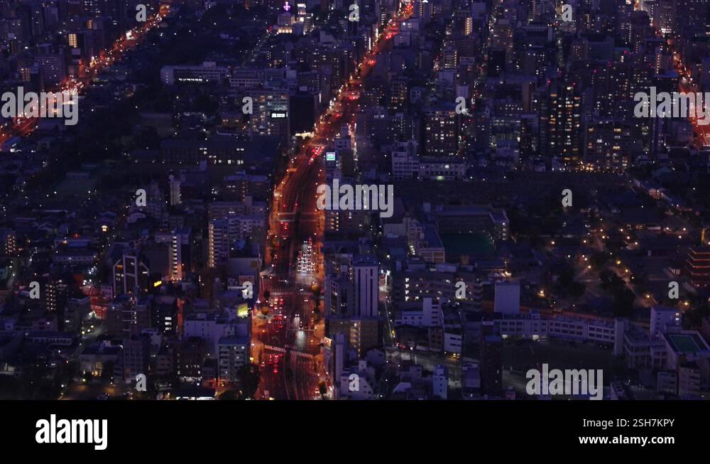 Night City, Osaka Aerial Tilt View revealing lights of Japanese City ...