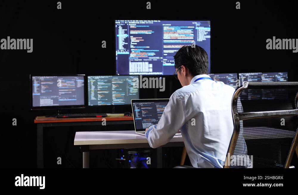 Back View Of Asian Male Programmer Writing Code By A Laptop Using ...