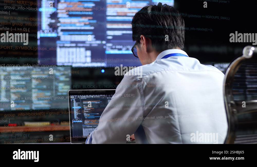 Back View Of Asian Male Programmer Writing Code By A Laptop Using ...