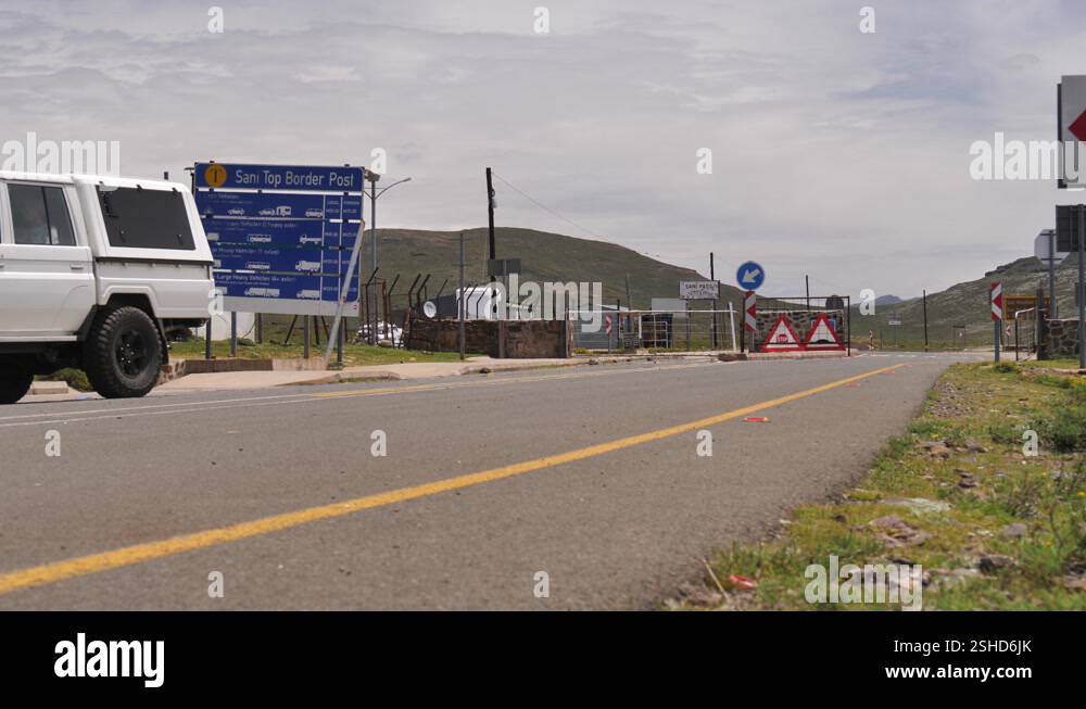 White truck leaves Lesotho border control post to descend Sani Pass ...