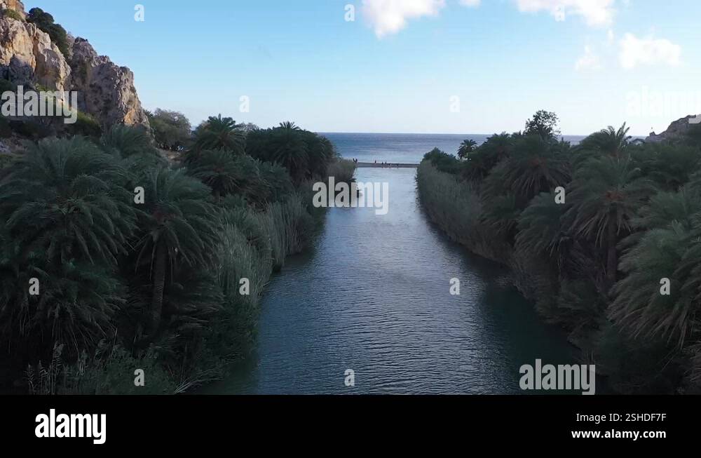 The drone captures the serene beauty of a river winding its way through ...