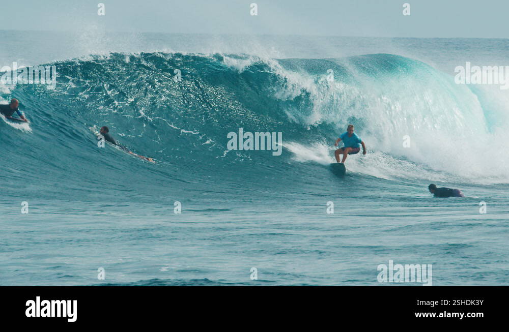 Surfer surfs the wave. Male surfer rides the wave in the Maldives Stock ...