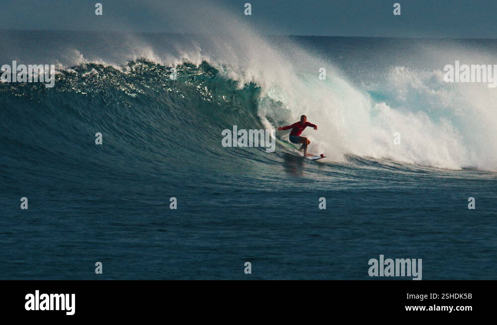 Surfer surfs the wave. Male surfer rides the wave in the Maldives Stock ...