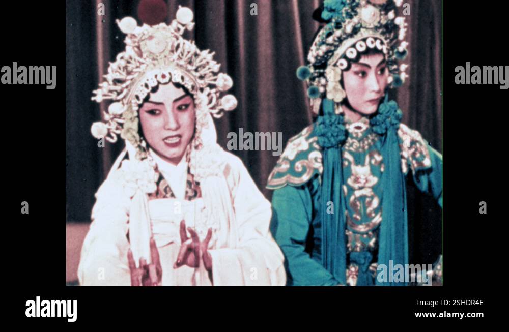 1950s: People onstage at the Peking Opera in costume. People dance and ...