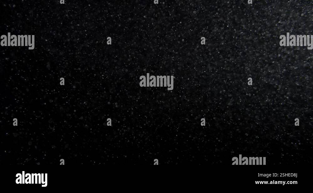Dust particles overlay on black screen. Filmed with RED camera in slow ...