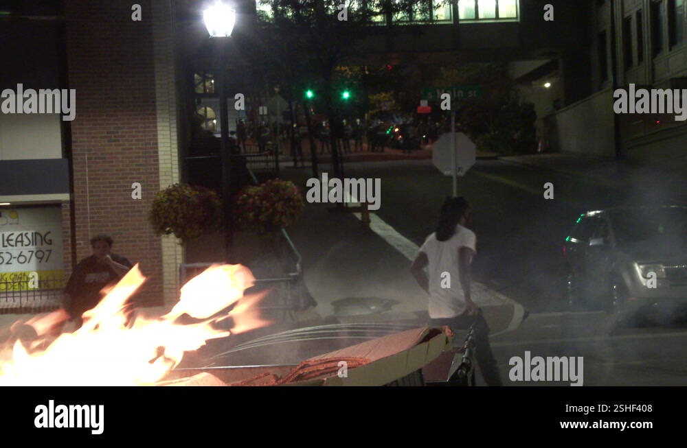 Riot police stand behind burning dumpster Stock Video Footage - Alamy