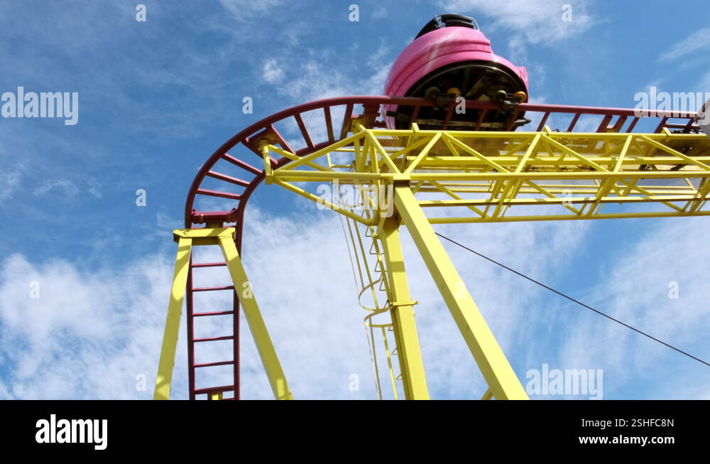 Top down view of roller coaster trolley at amusement park against blue ...