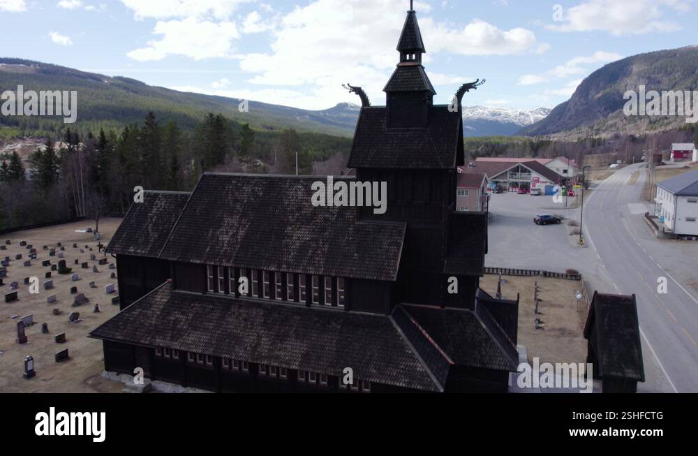 Ascending aerial view in front of a stave church replica, spring in ...