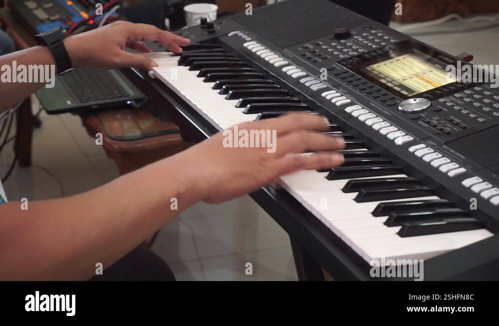 Hands of a composer playing the piano, synthesizer, electronic piano ...