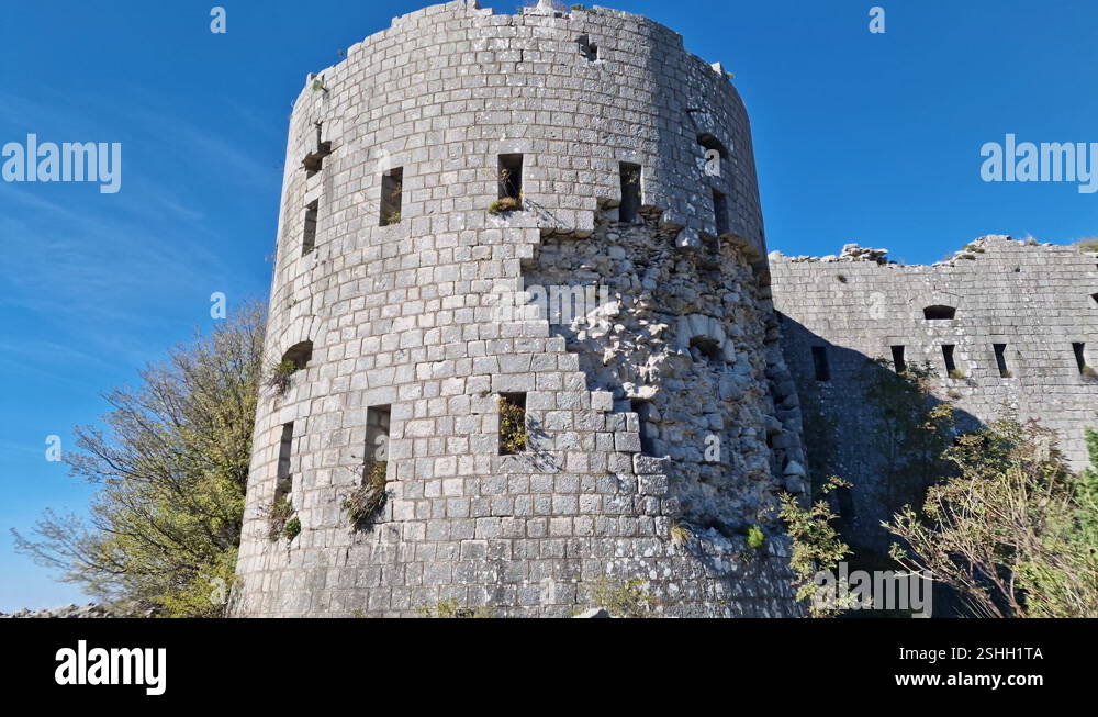 Stone castle - derelict round tower of a fortress on a sunny day, under ...