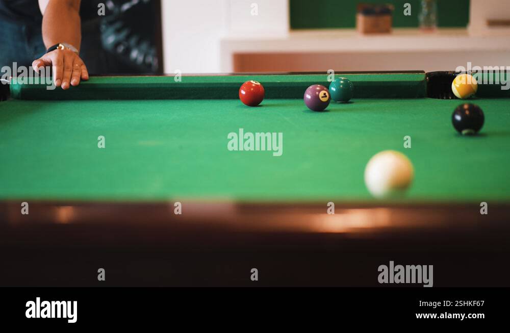 Sinking nine ball on billiard table with a nice shot rebound with white ...