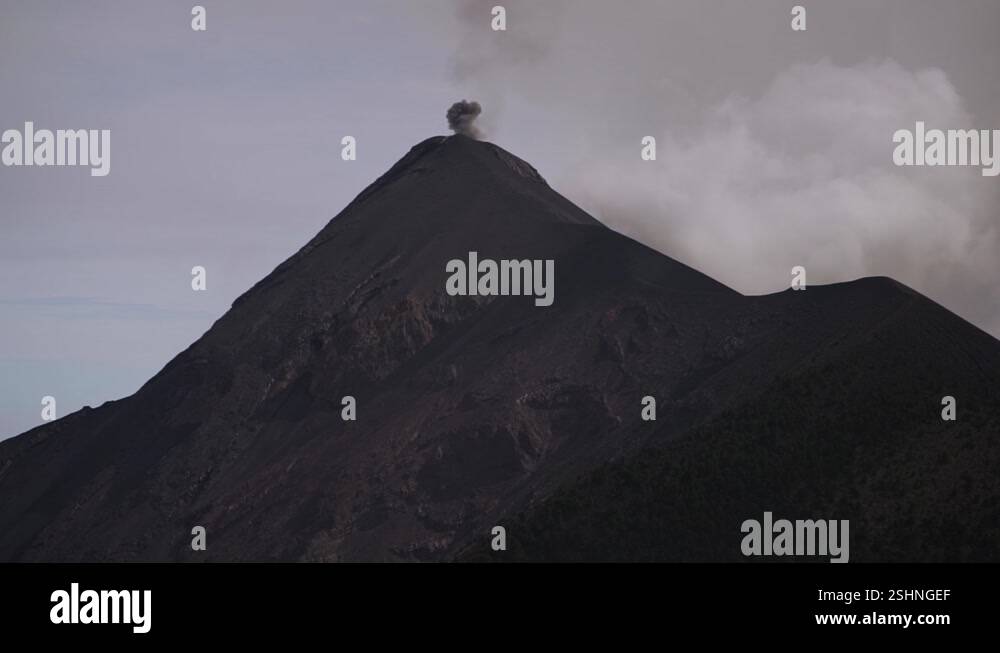 Camera pan zoomed in on a erupting volcano in Guatemala Stock Video ...