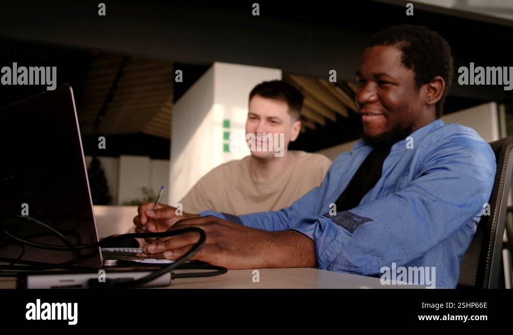 Two programmers working in the office of a software development company ...