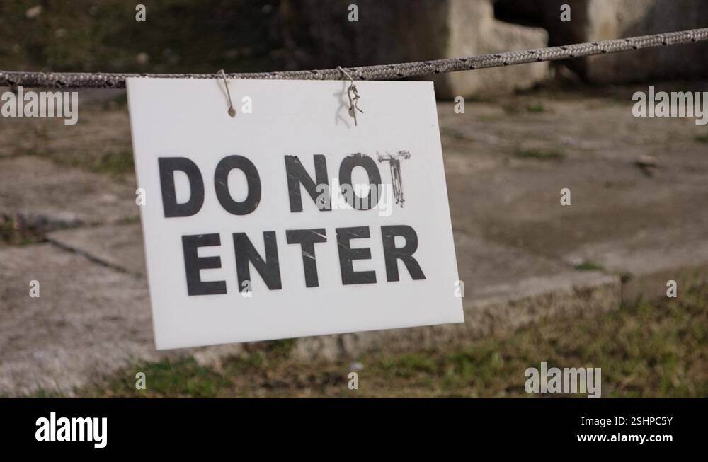 Do Not Enter warning sign on a rope in slight breeze Stock Video ...