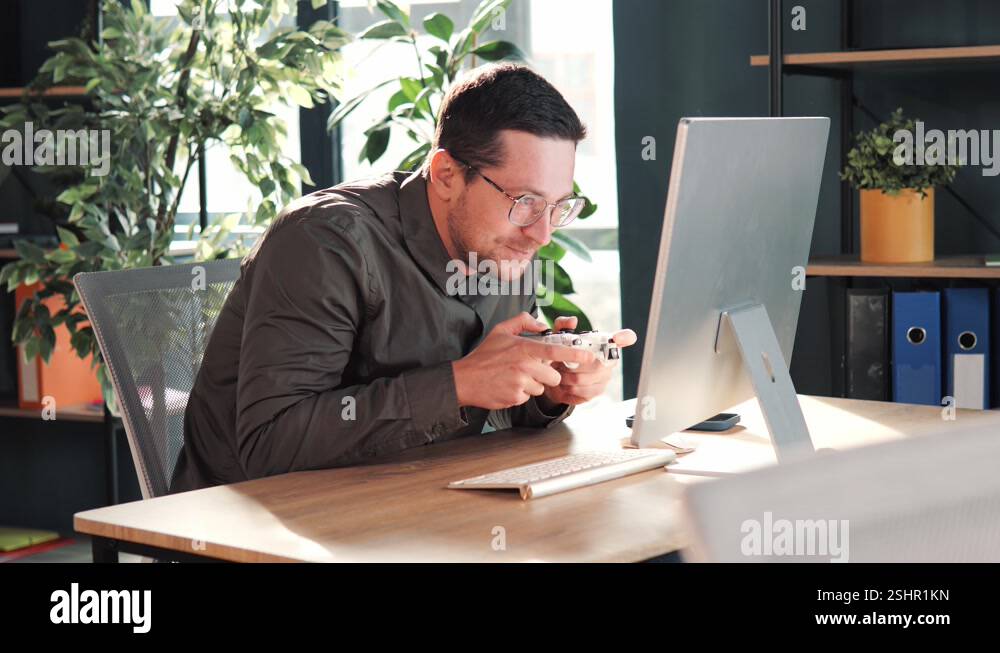 Confused comic office worker gamer hold controller joystick playing ...