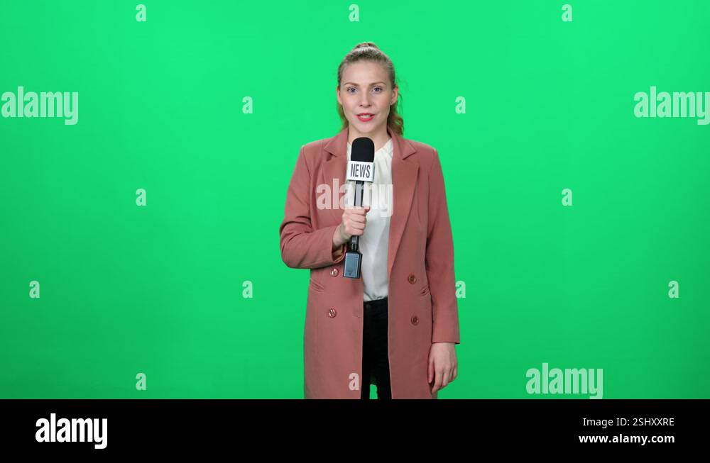 News, woman news reporter speaks into a microphone on a green ...