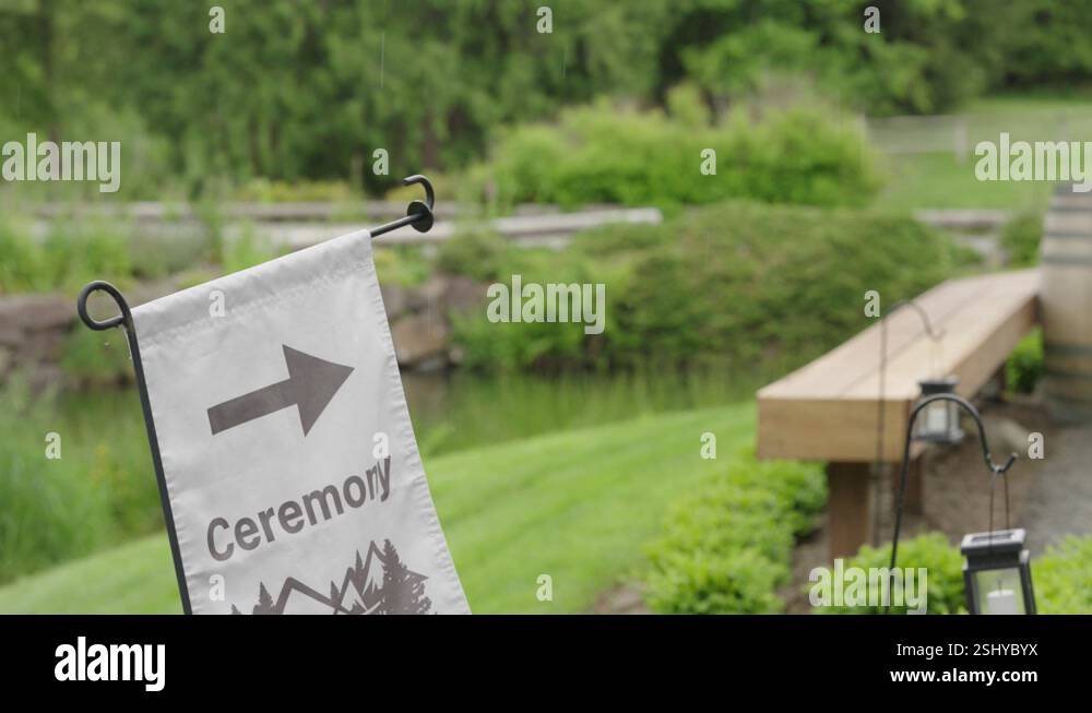 Sign that says ceremony on a farm. It rains lightly. The place is a ...