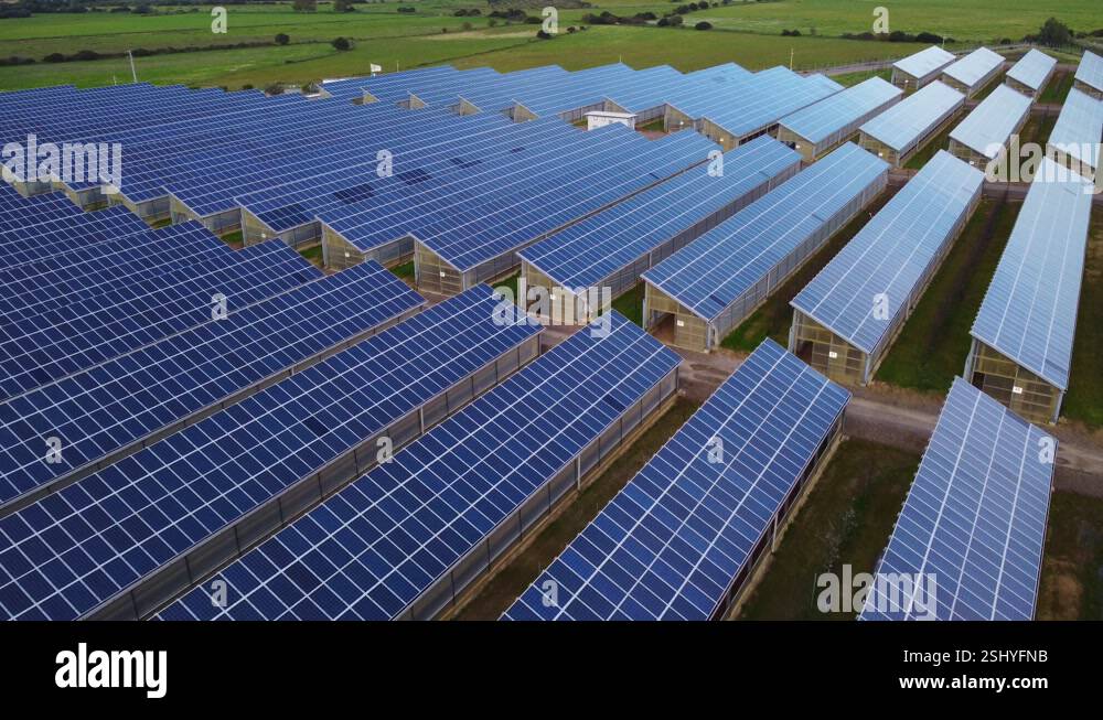 Blue solar panel array with thousands of solar panels on roofs of Stock ...