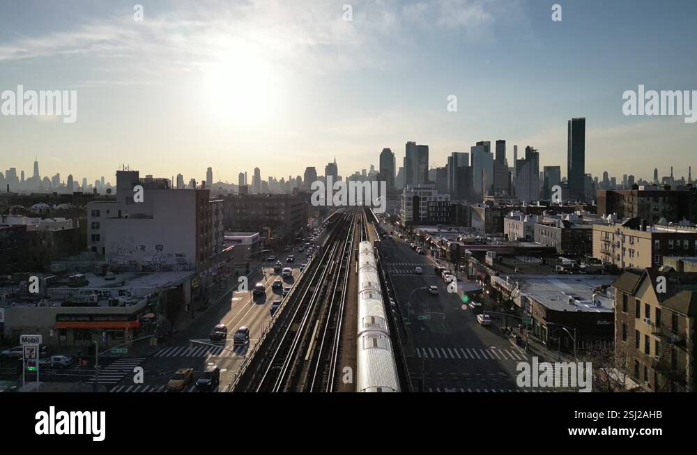 A stunning aerial view above an elevated subway train at sunset, with ...