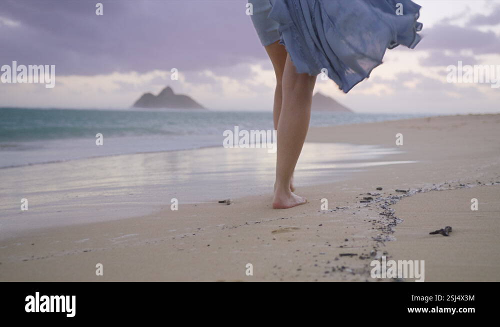 Close up woman feet walking barefoot by beach leaving footprints in ...
