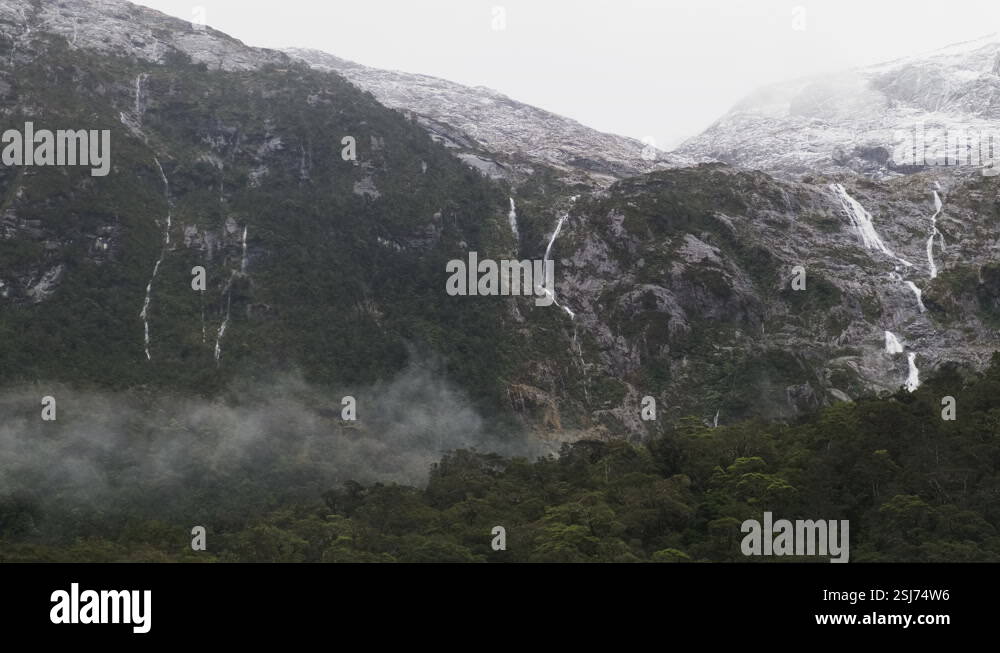 Majestic waterfalls cascading down the fjord mountains in New Zealand's ...