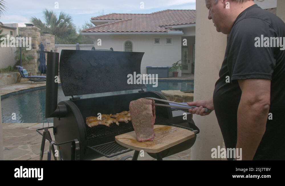 Man puts rack of BBQ ribs on to hot grill in his back yard Stock Video ...