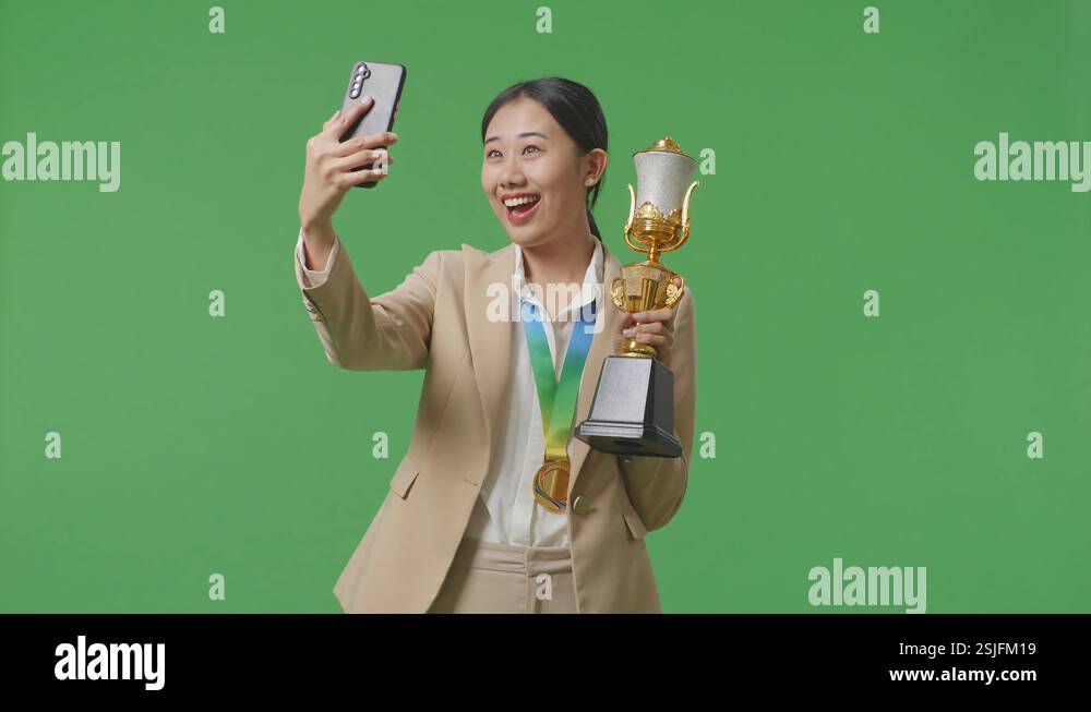 Asian Business Woman In A Suit With A Gold Medal Holding A Gold Trophy ...