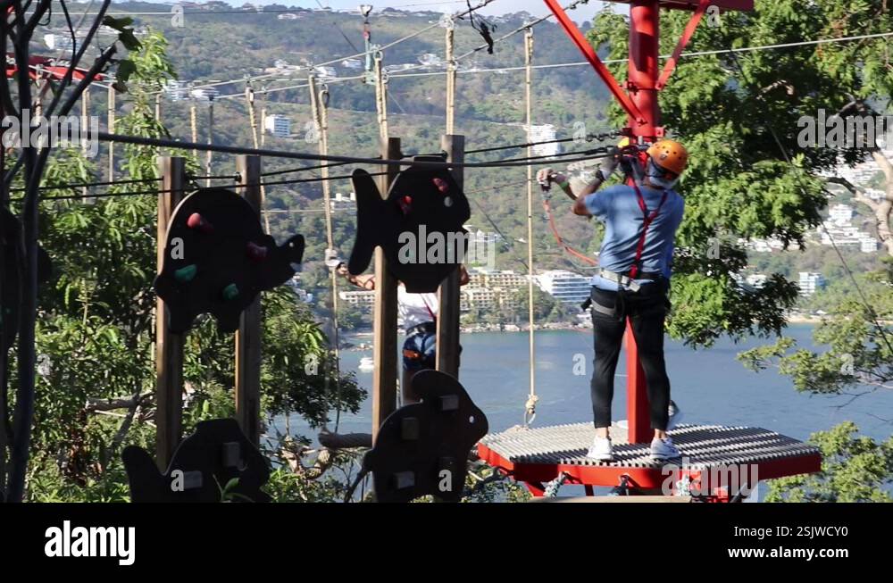 People walking on hanging wooden walkways through ropeway in a Stock ...