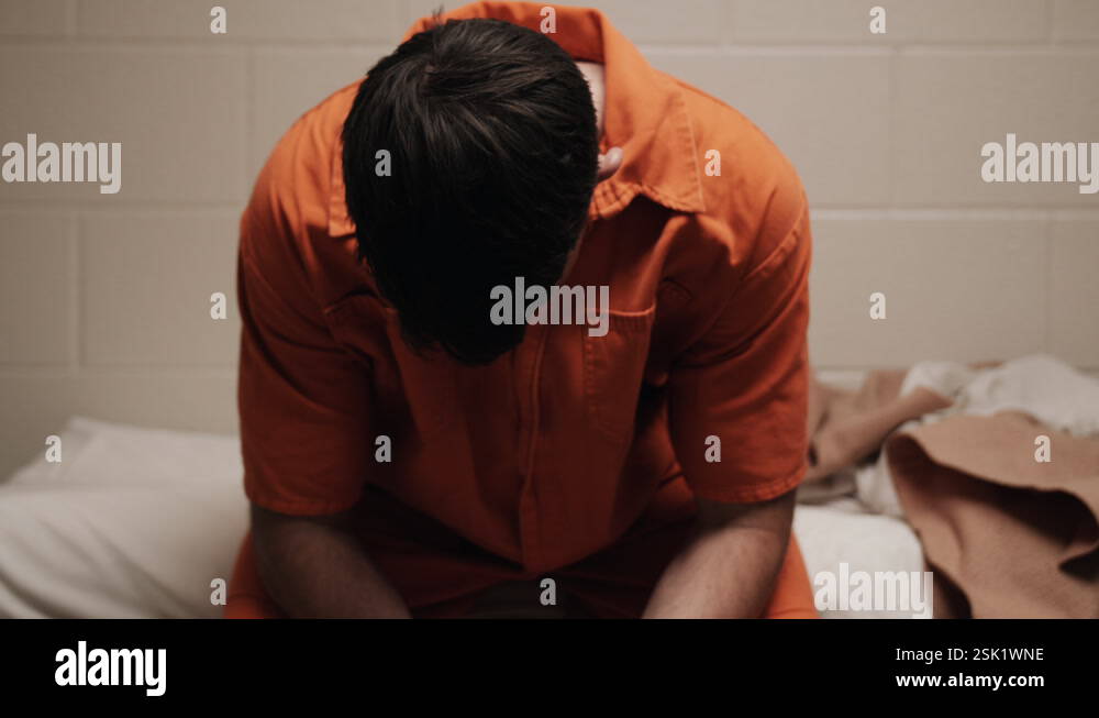A sad, depressed attractive, handsome man, criminal prisoner, inmate in ...