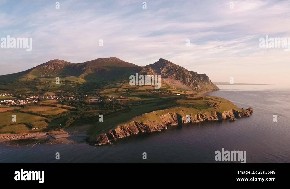 Aerial approach to Mountain range Yr Eifl at Trefor with blue skies on ...