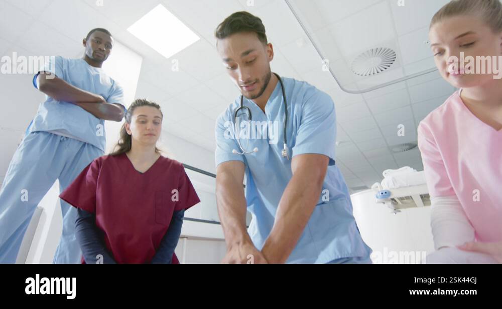 Biracial doctor training trainee doctors in emergency cpr procedure ...