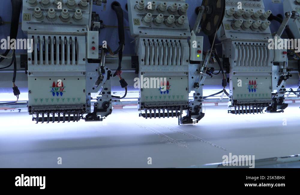 Row Of Automatic Fabric Stitching Machines At Garment Factory In ...