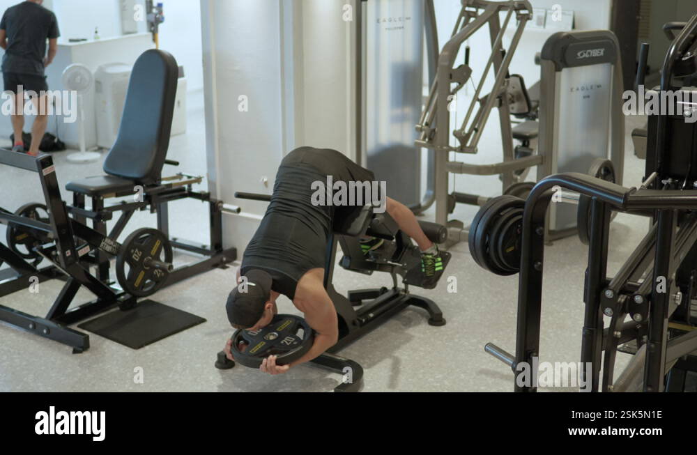Man Doing Lower Back Extension or Hyperextension Exercise with 20kg ...
