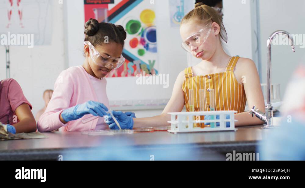 Diverse happy schoolchildren having science class in school lab Stock ...