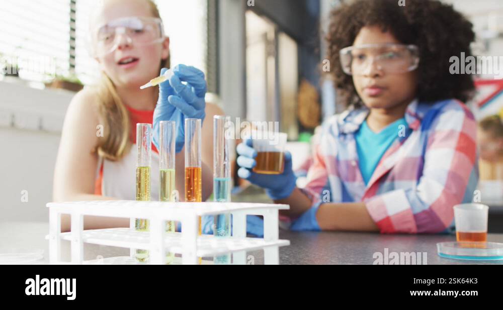 Diverse happy schoolchildren having science class in school lab Stock ...