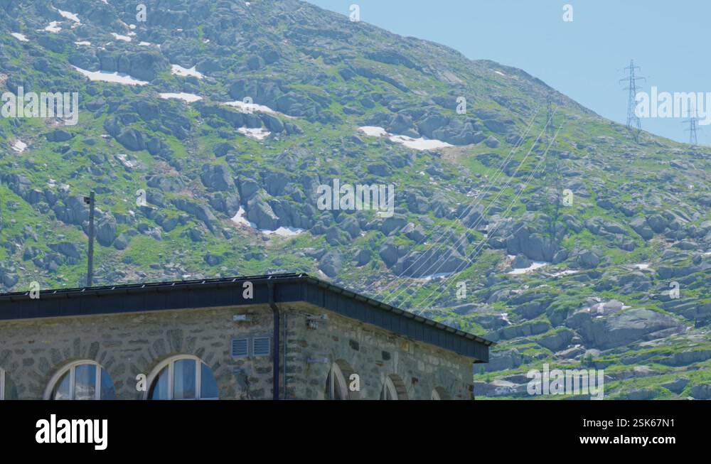 Building and Pylons in the Swiss Alps, on a clear day with blue skies ...
