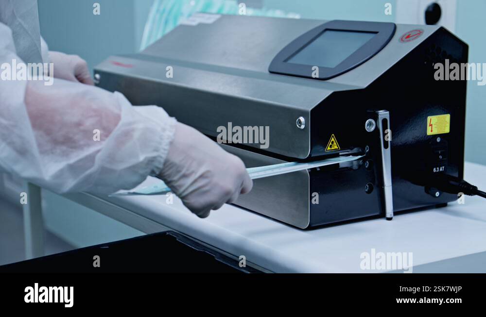 Factory workers packaging medical products. Production of cytobrush ...
