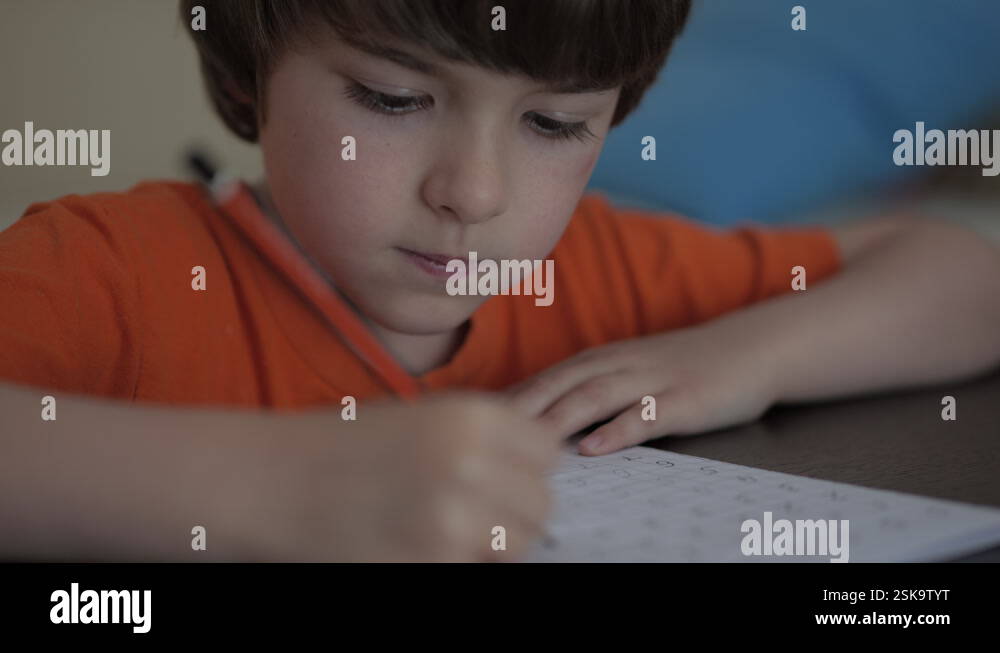 School Boy Practicing Writing Numbers at Home. Child Working on His ...
