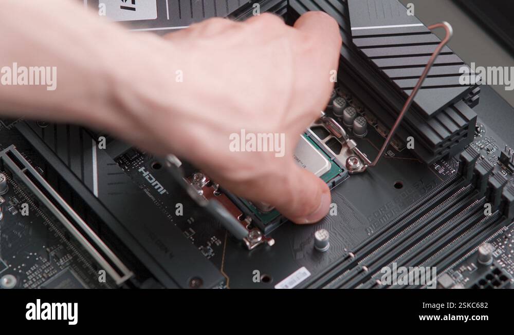 Man removing a CPU from a motherboard. Computer hardware. Close up ...