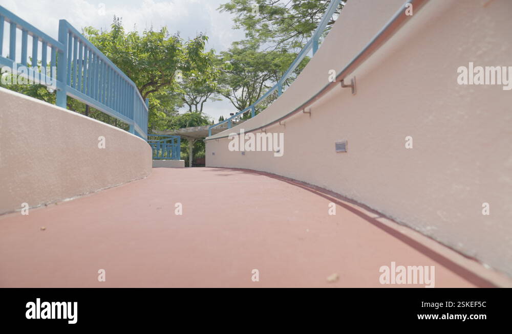 Low-angle shot moving up a ramp in a peaceful park in Hong Kong Stock ...