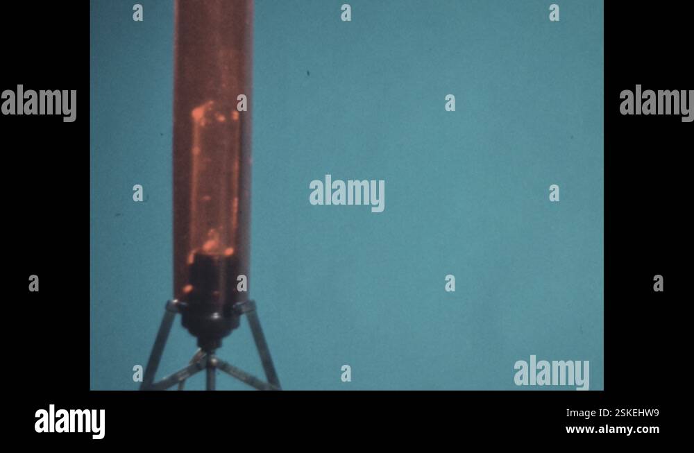 1960s: A glowing electric bulb is mounted on beam connected to metal ...