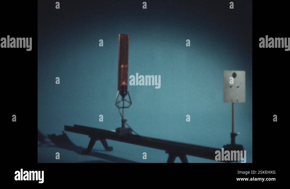 1960s: A glowing electric bulb is mounted on beam connected to metal ...