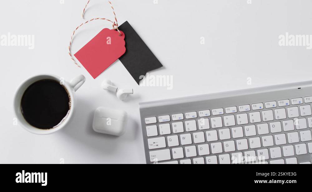 Video of computer keyboard, cup of coffee, earphones, gift tags with ...