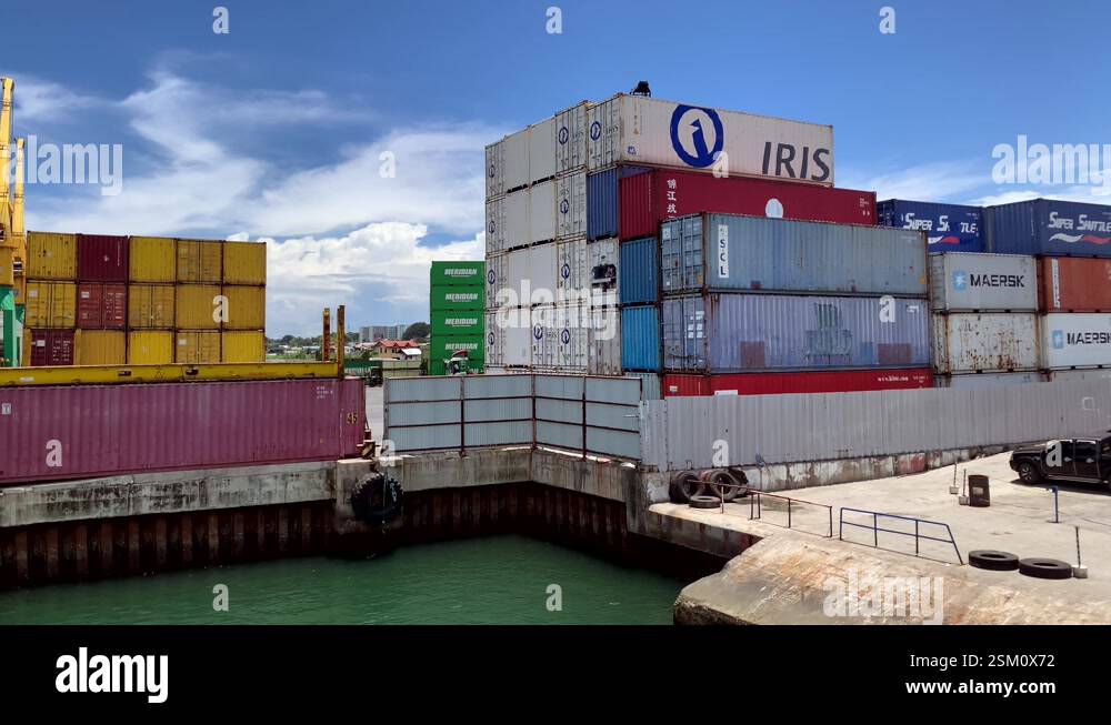 Multiple layers of large shipping containers are stacked, set against ...